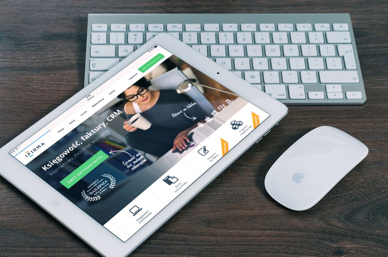 who-we-are A tablet with a financial website open, alongside a white keyboard and mouse. Ideal for tech-theme stock images.