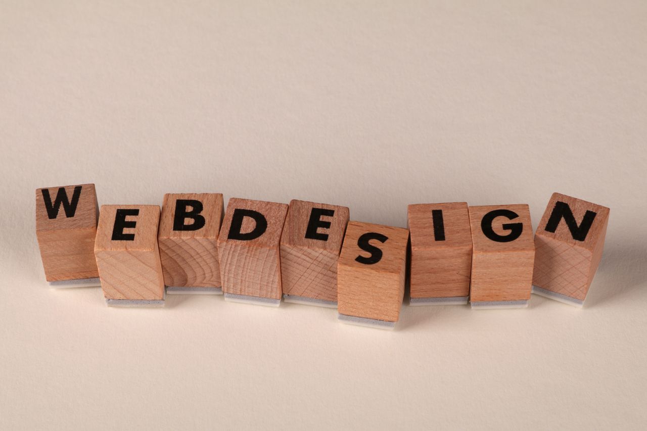 why-choose-us Wooden blocks spelling web design creatively showcase digital design concept.